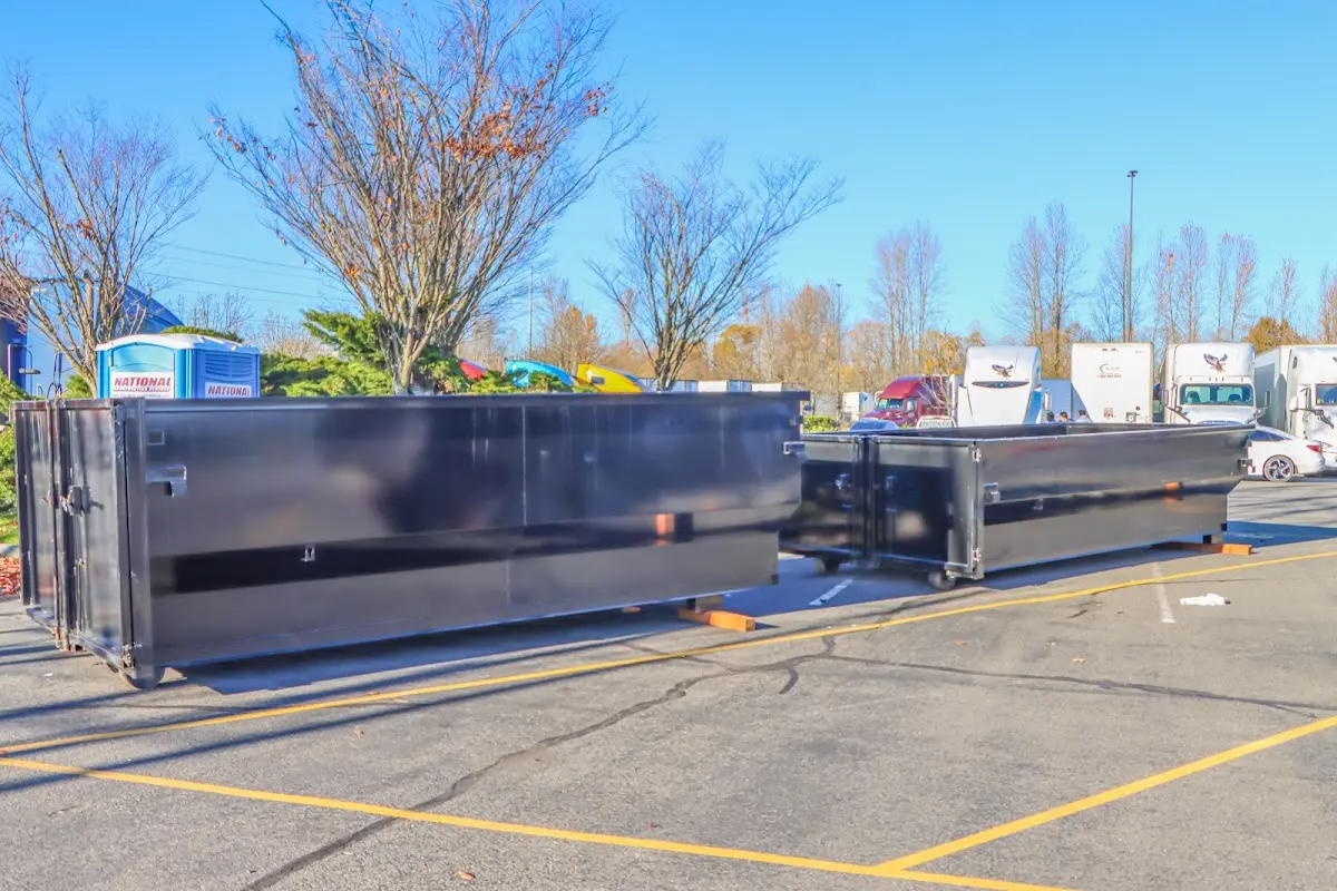 Professional dumpster rental service with roll-off container on residential driveway in Merrill